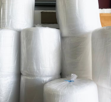 a bunch of rolls of plastic wrappers bubble wrap rolls