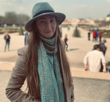 a woman in a hat and scarf on a sunny day