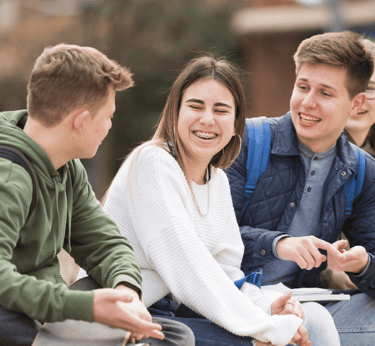 a group of young people sitting on a bench