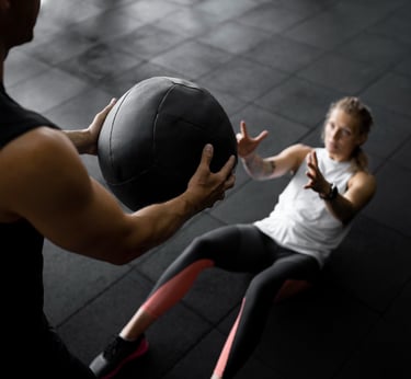 A personal trainer coaching a client how to do abs exercises