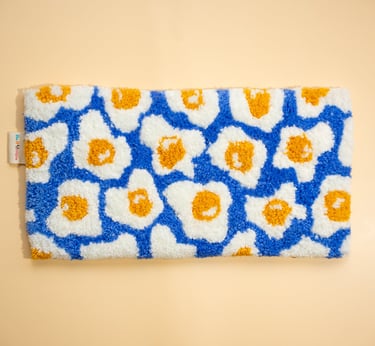 a blue and white toiletry bag with a blue and yellow flower pattern