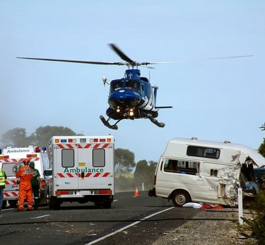 Ambulance and helicopter on scene where paramedics are using POCUS ultrasound.