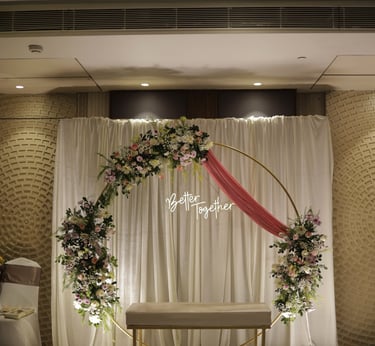 a wedding ceremony with a floral arch