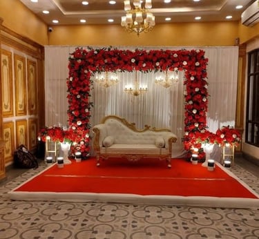 a wedding ceremony with a red carpet and a white couch