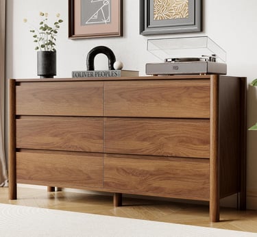 Mid-century modern walnut wood dresser with six drawers and a vintage record player on top.