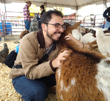 Luis at a petting zoo hugging a goat that took to him very well!