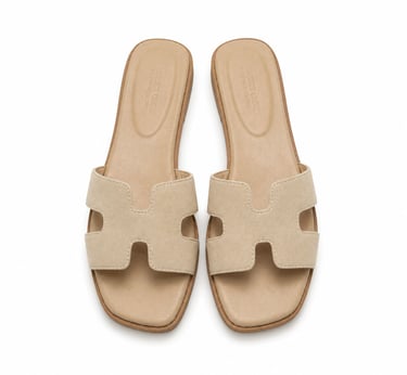 Minimal beige suede slide sandals.