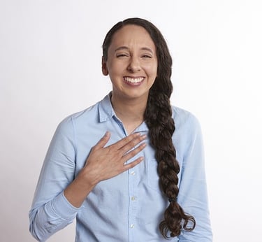  woman with braid & hand over heart, smiling