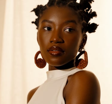 "Close-up headshot of a Nigerian spoken word poet and actor looking intensely at the camera.