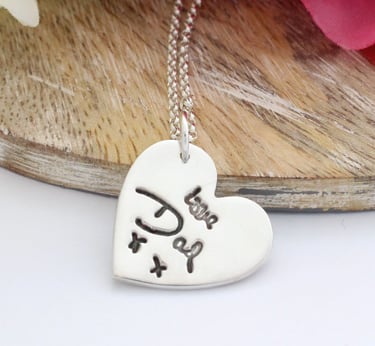 Handwriting taken from a card and pressed into a silver heart shaped pendant