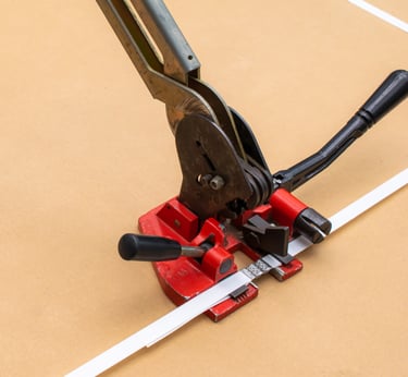 Manual strapping machine and white plastic strap used for sealing and packing
