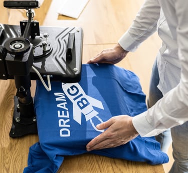 a person is holding a blue shirt and a blue shirt