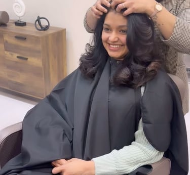 a woman getting her hair cut by a hairdresser