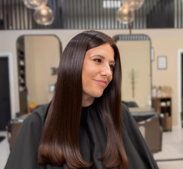 a woman in a salon with a haircut