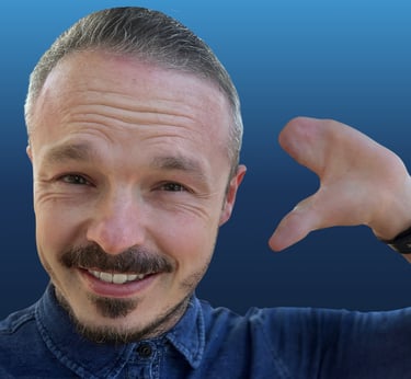 A white male holding up their upper limb difference