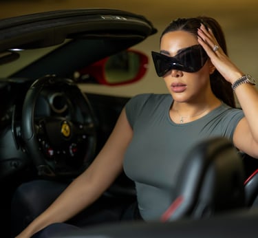 Close-up of model wearing sunglasses inside luxury car, captured by Fred Art Studio.