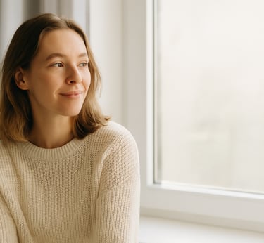 A young woman smiling in soft sunlight, representing hope and new beginnings in recovery.