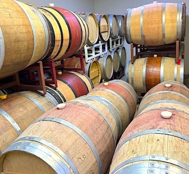 Brown and tan wine barrels stacked on racks