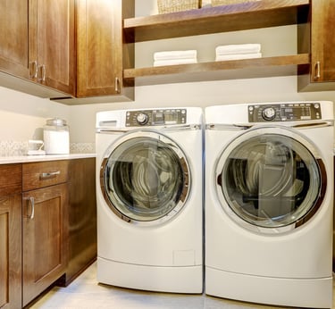 A laundry room with a white washer and dryer set