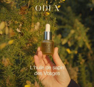 a person holding a bottle of oil and a bottle of oil