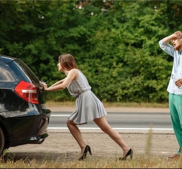 the man watches as the woman pushes the car