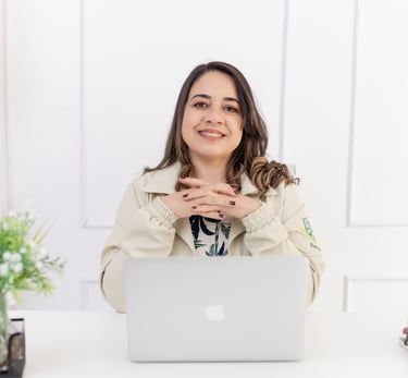 a woman sitting at a desk with a laptop