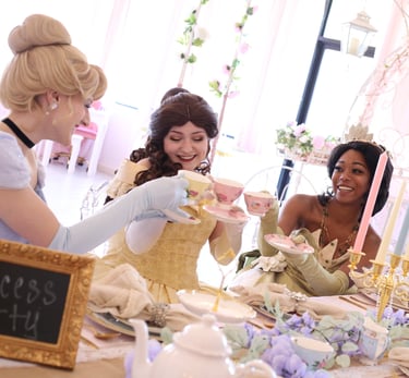 Tiana, Belle, and Cinderella cheers with tea cups