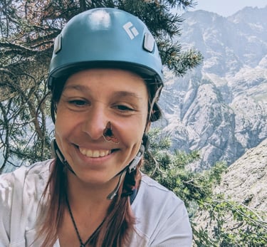 a woman in a helmet on a mountain