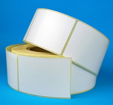 two rolls of white labels on a blue background