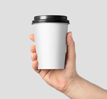 a person holding a cup of coffee in their hand