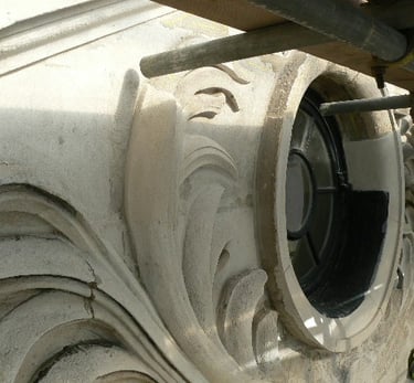 a property with a circular portland stone window and a circular restored moulding