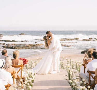 Bride and groom kissing on the beach destination wedding