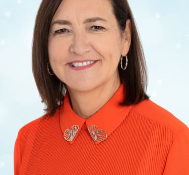 a woman in a red shirt and earrings