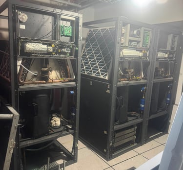 Industrial HVAC precision cooling units with exposed wiring and internal components in a data center server room.