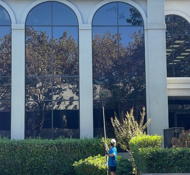 a man is cleaning a lawn in front of a building