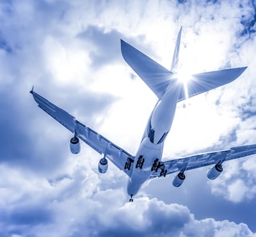 Airplane flying through clouds with sunlight capturing the feeling of Disney adventure