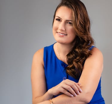 a woman in a blue dress sitting on a chair