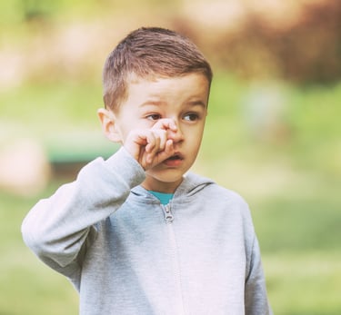 Child rubbing his eye