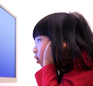 Child staring at a screen closely