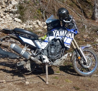 a motorcycle parked on a dirt road