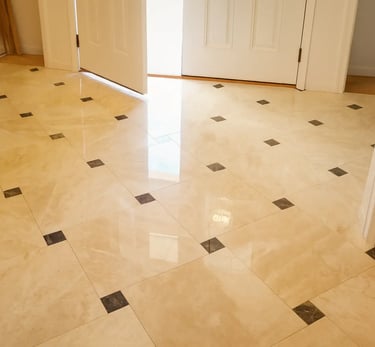 professionally installed polished marble tiles accented with contrasting dark inlays.