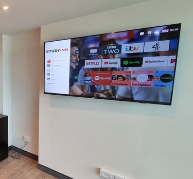 MountMyTV - Samsung 65" TV mounted on a wall in a university communal area