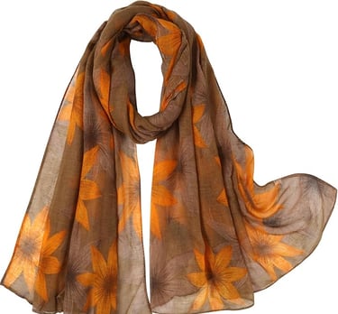 Lightweight floral leaf print fall scarf in brown-yellow tones, styled as a shawl or wrap.