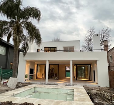 a house with a pool and a palm tree