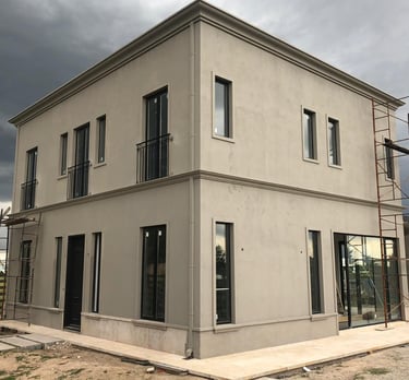 a house with a large window and a ladder