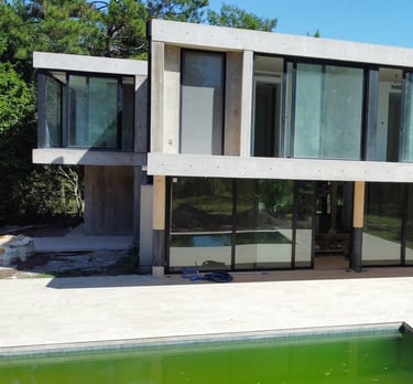 a house with a pool and a pool in the background