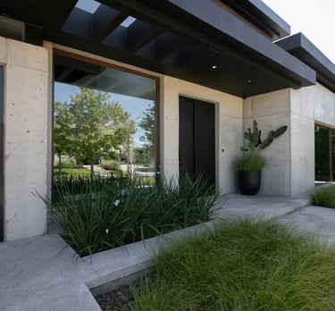 a house with a large window and a potted planter