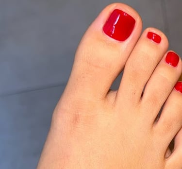 a person with red nails and red nails on their toes