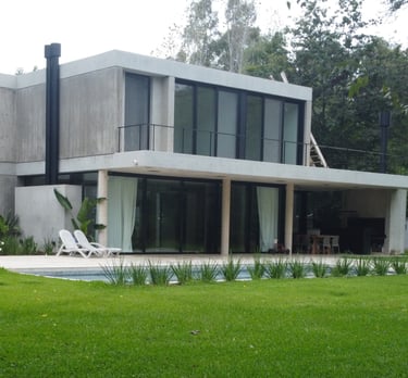 a house with a pool and a pool in the grass