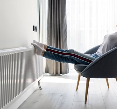 a woman sitting in a chair with her legs up